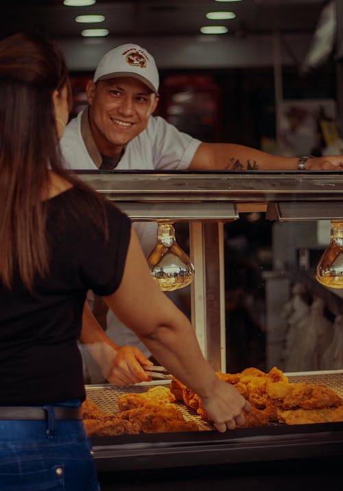 Chef Smiling and Looking at Customer Standing by Bar Counter