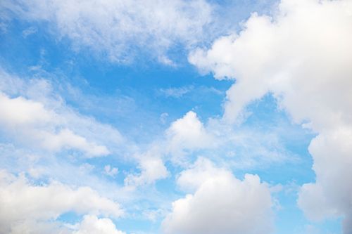 Free Bright blue sky filled with fluffy white clouds on a clear day. Stock Photo