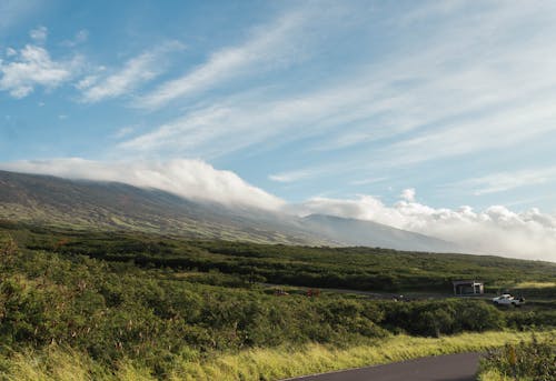 Clouds on Blue Sky over Hill and Road