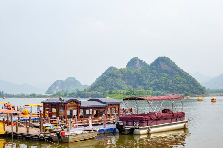 Wooden Pier And Boats On Li River In Guangxi, China