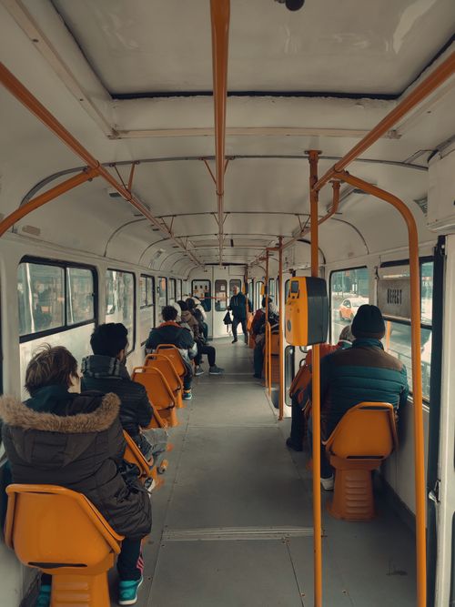 Free A diverse group of passengers seated inside a Bucharest tram during daytime. Stock Photo