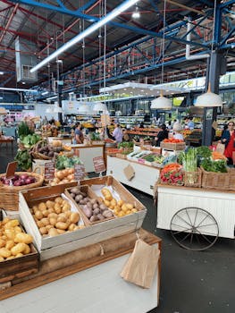 Bustling indoor farmer's market with diverse fresh produce and engaging retail atmosphere.