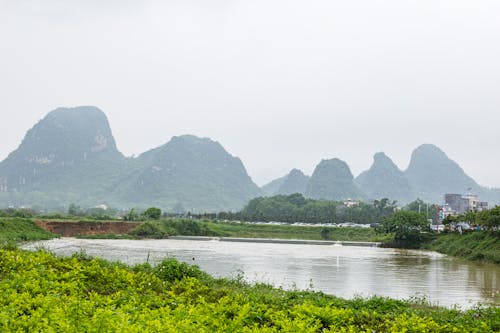 Landscape of a Lake and Mountains in Fog 