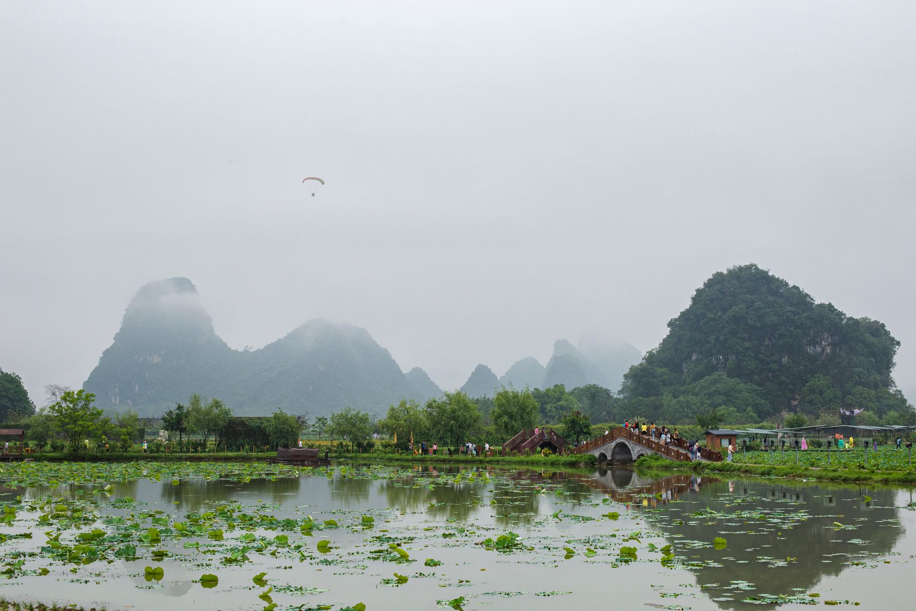A picturesque misty landscape featuring a historical bridge and lush greenery in Vietnam, perfect for travel promotion.