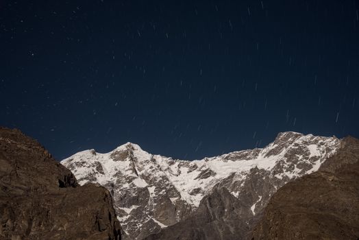 Capture of snowy mountains and starry night sky in Hunza Nagar, Pakistan.