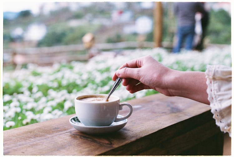 Woman Spooning Coffee