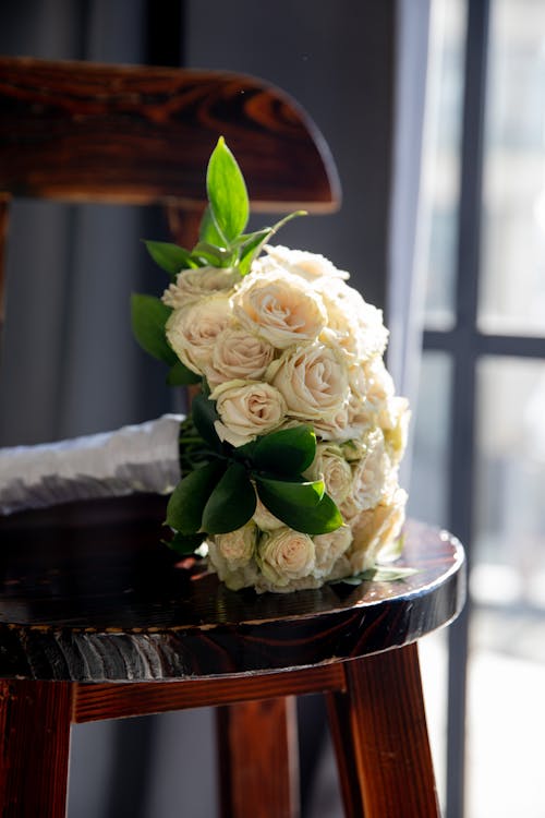 Close-up of a Bouquet of White Roses Lying on a Wooden Chair 