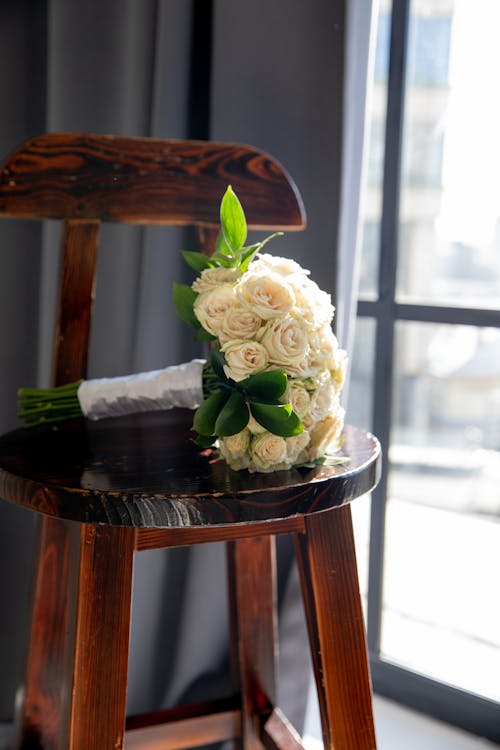 Bouquet of White Roses on a Wooden Chair 