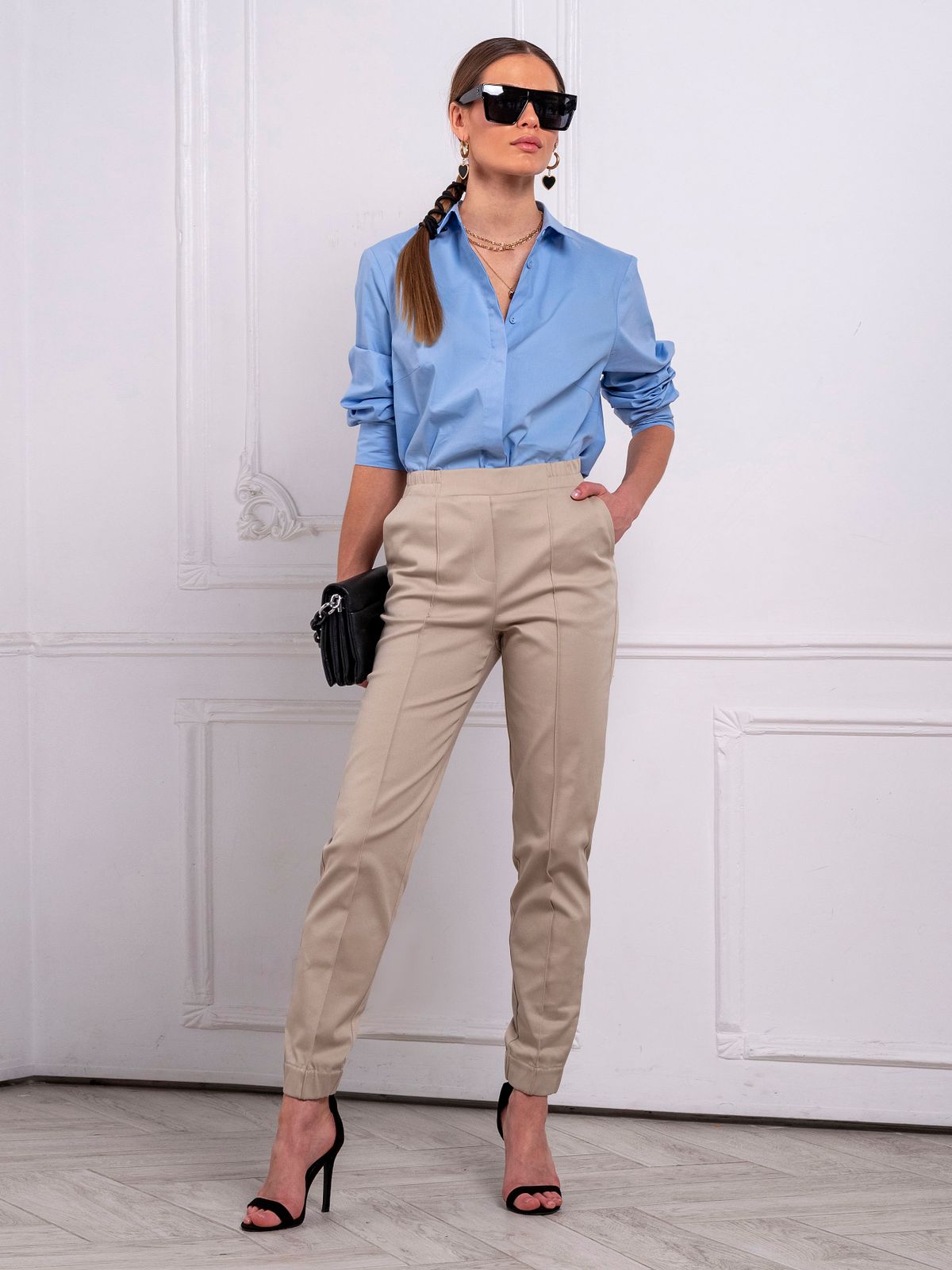 An elegant woman posing — the polished capri-pant top