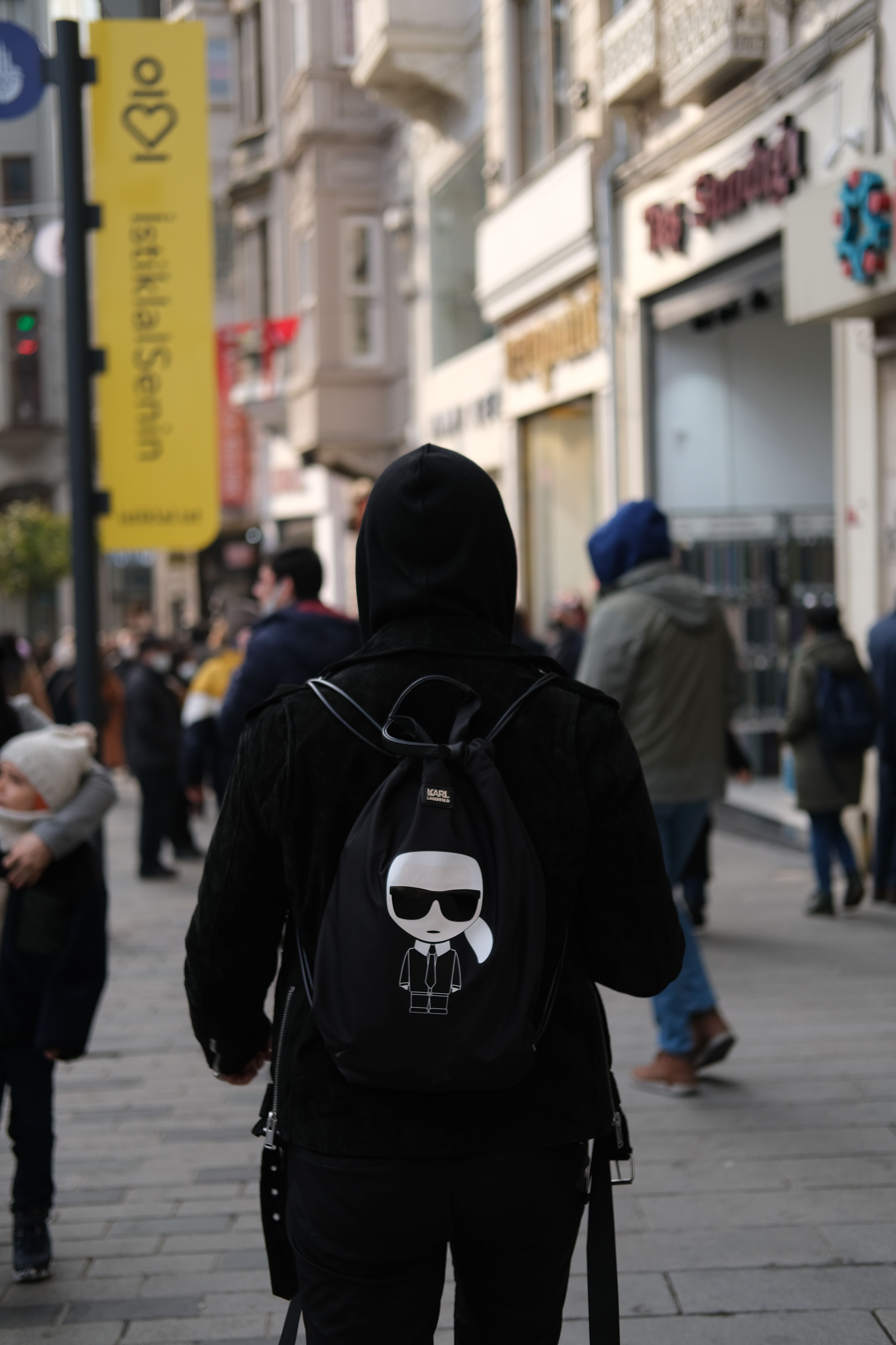 Back View of a Man with a Backpack Walking on a City Street · Free ...