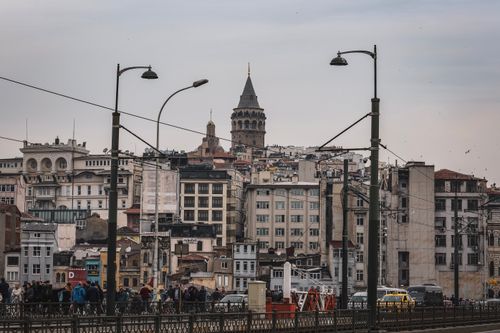 Free The iconic Galata Tower rises over the bustling streets of Istanbul, capturing city life and architecture. Stock Photo