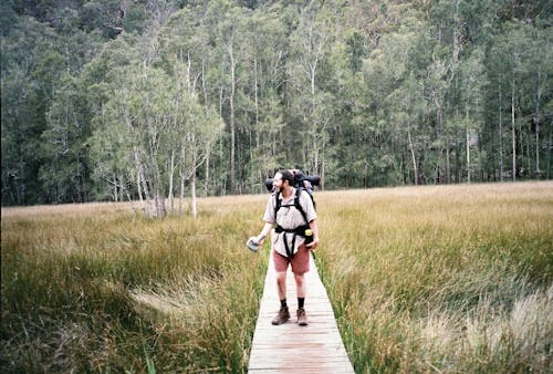 A Man Standing on a Footbridge 