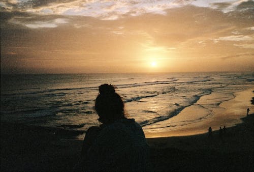 Silhouette of a Woman on the Beach at Sunset 