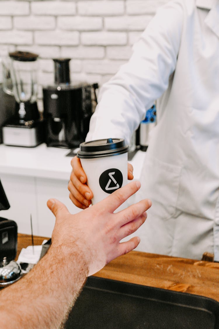 Customer Buying Coffee At Cafe