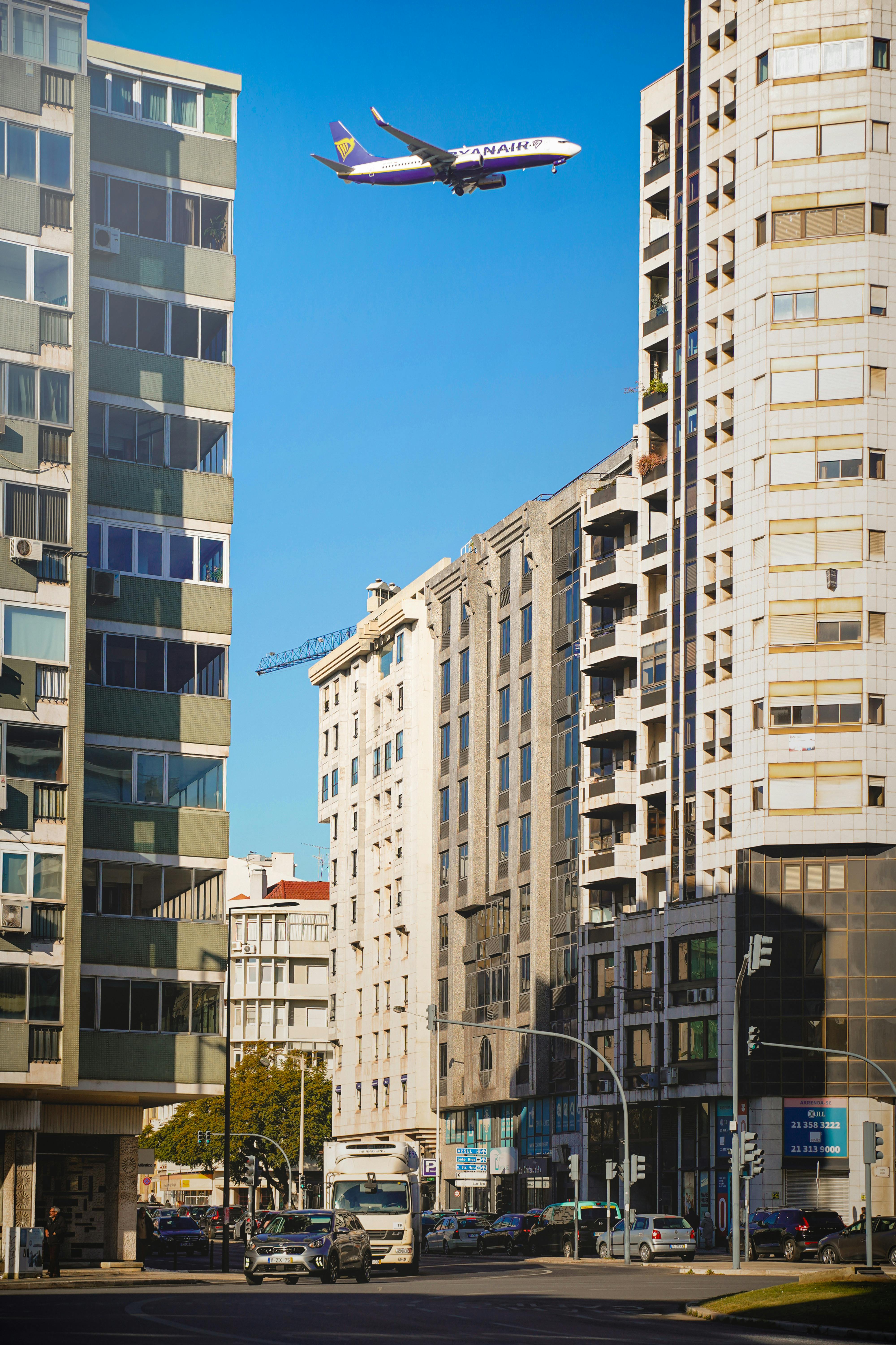 Plane Flying over the City · Free Stock Photo