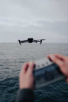 A drone captured flying over the ocean, controlled remotely. Serene seascape.
