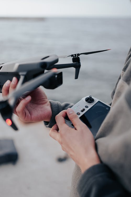 Close-up of a Person Holding a Drone and the Controller