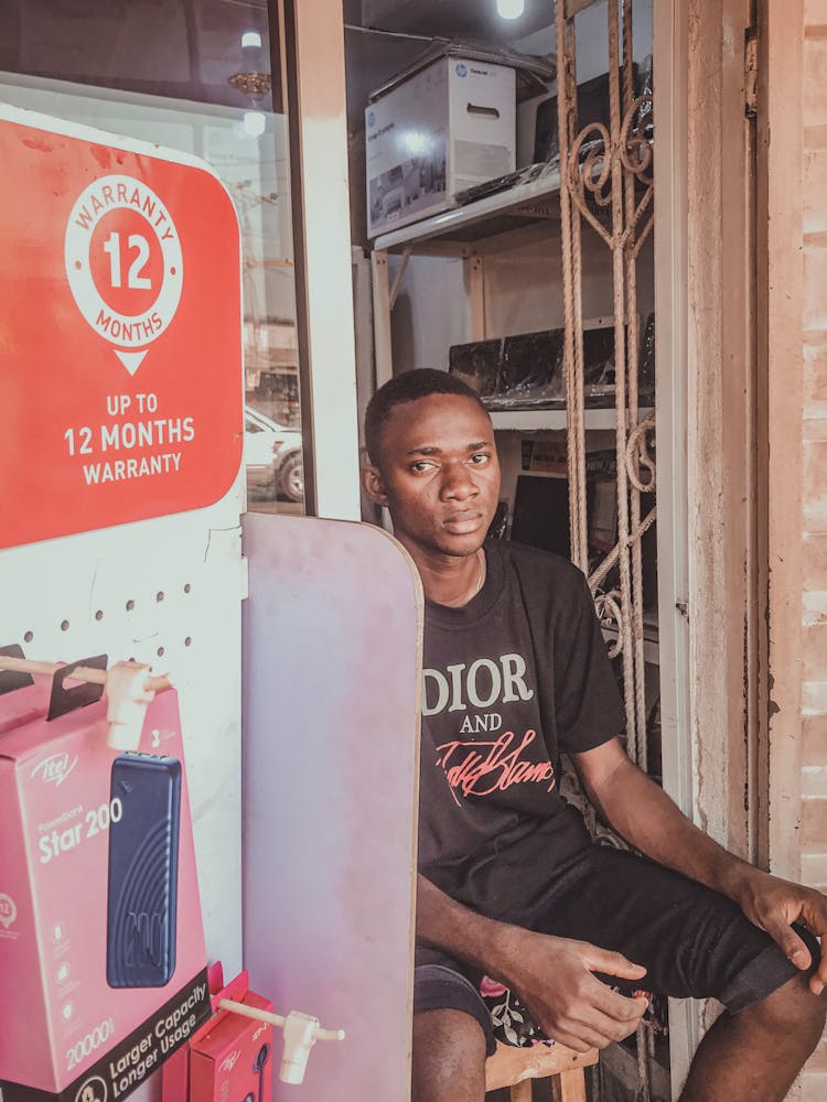 Young Man Sitting On A Chair In A Shop 