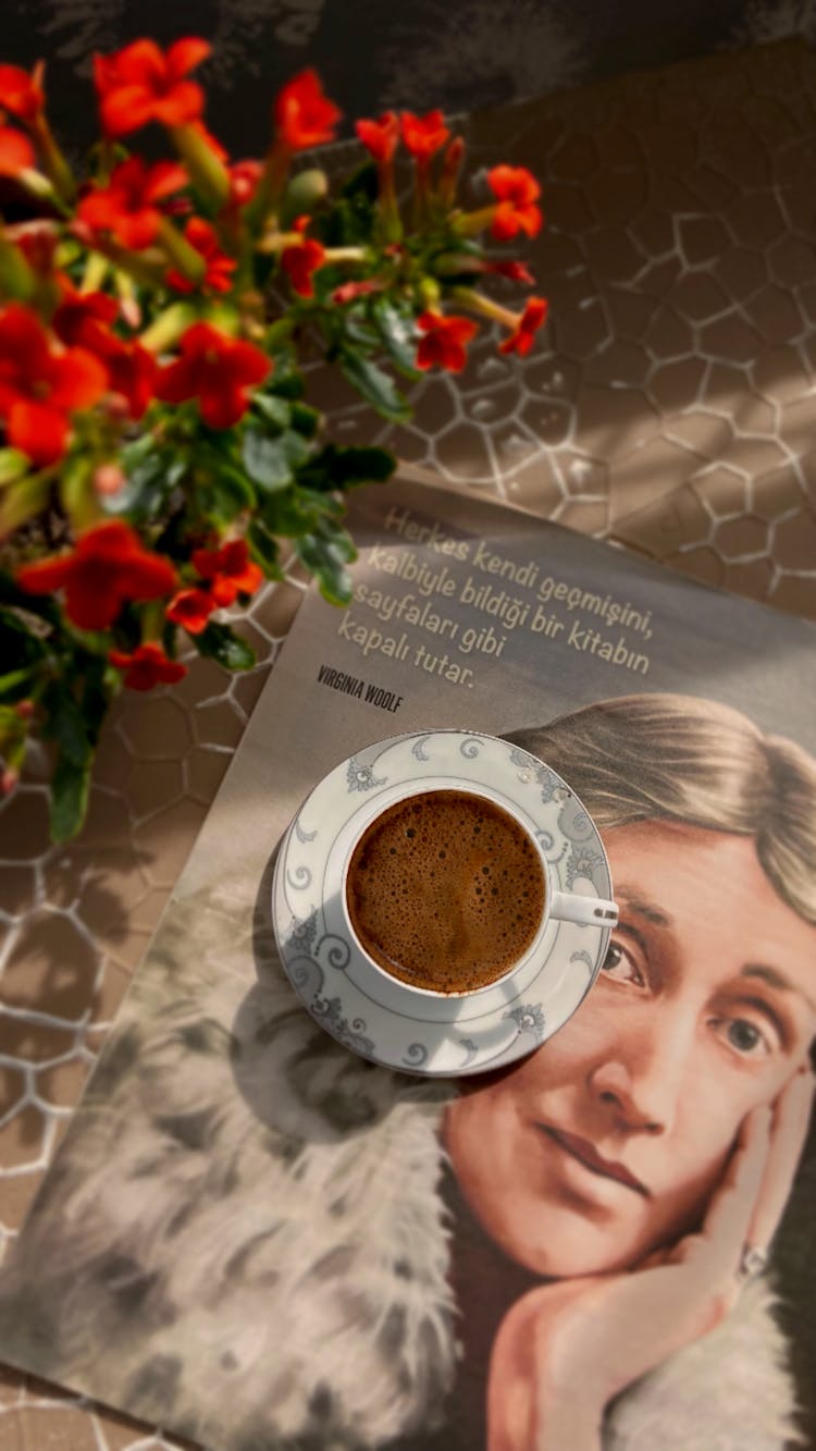 Photo Of A Cup Of Coffee On The Cover Of A Magazine