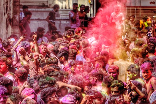 A lively crowd celebrates Holi with colorful powders in Udaipur, India.