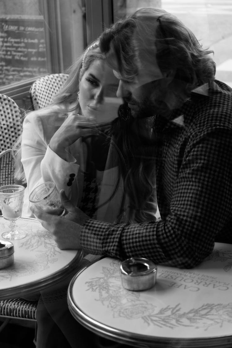 Couple Sitting Together In Cafe