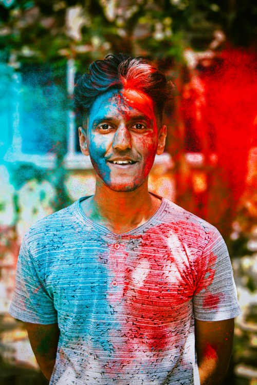 Free Vibrant portrait of a man covered in colorful powders during Holi festival in Kolkata. Stock Photo