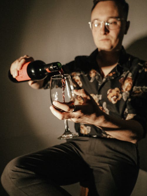 Man Pouring himself a Glass of Wine 