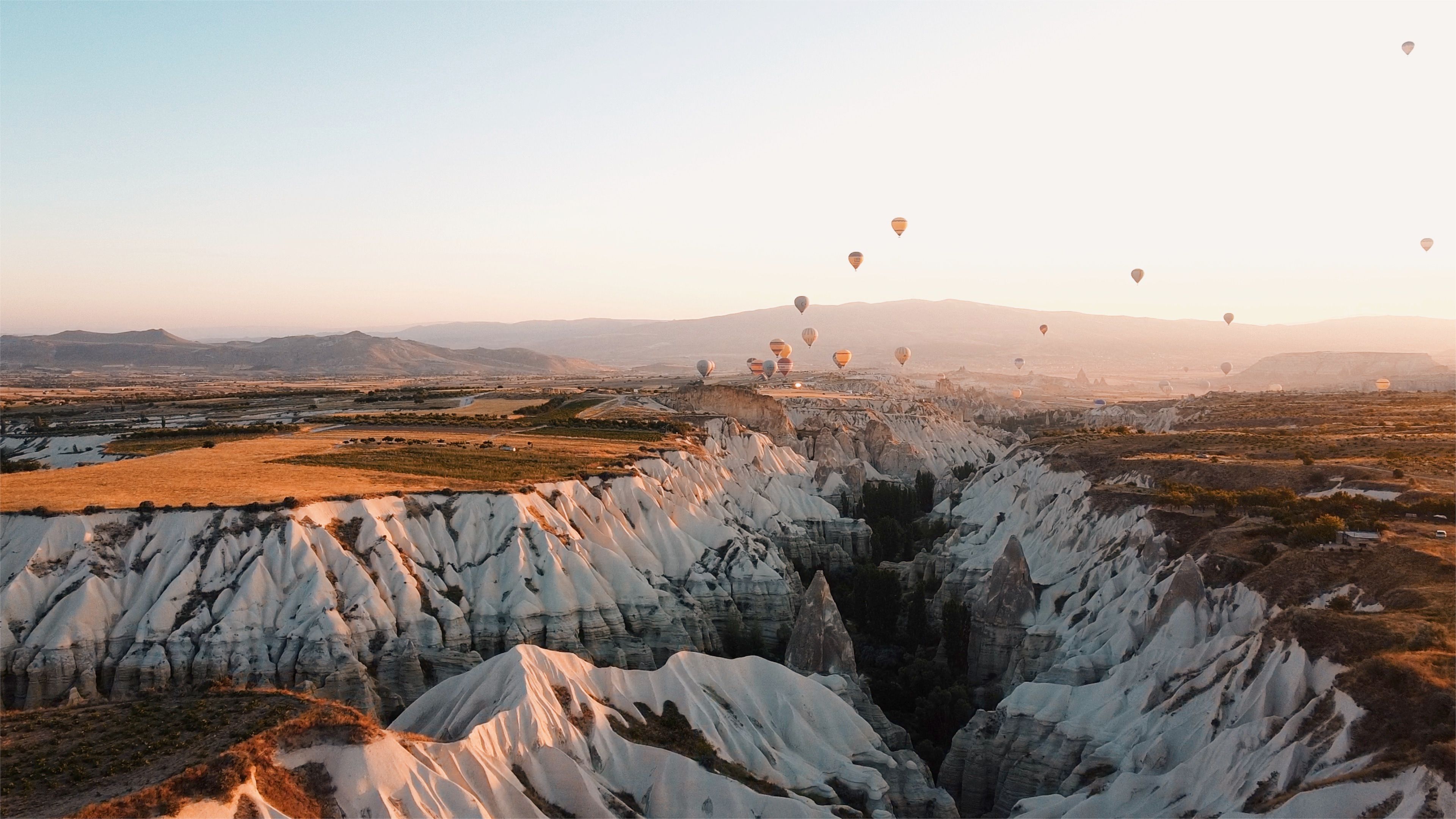 Hot Air Balloons Flying over Scenic Canyon · Free Stock Photo