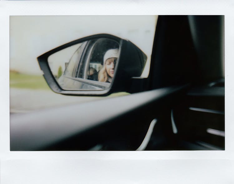 Woman Reflection In Car Mirror