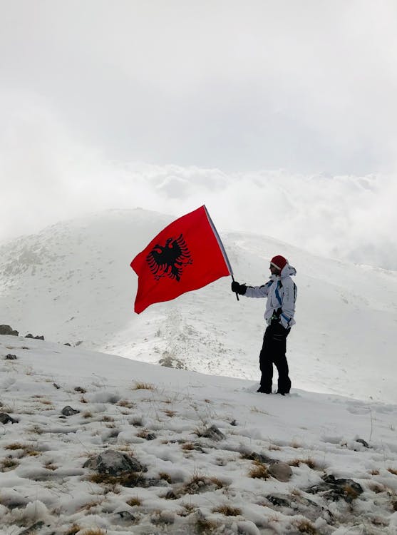 Man with Flag of Albania in Mountains