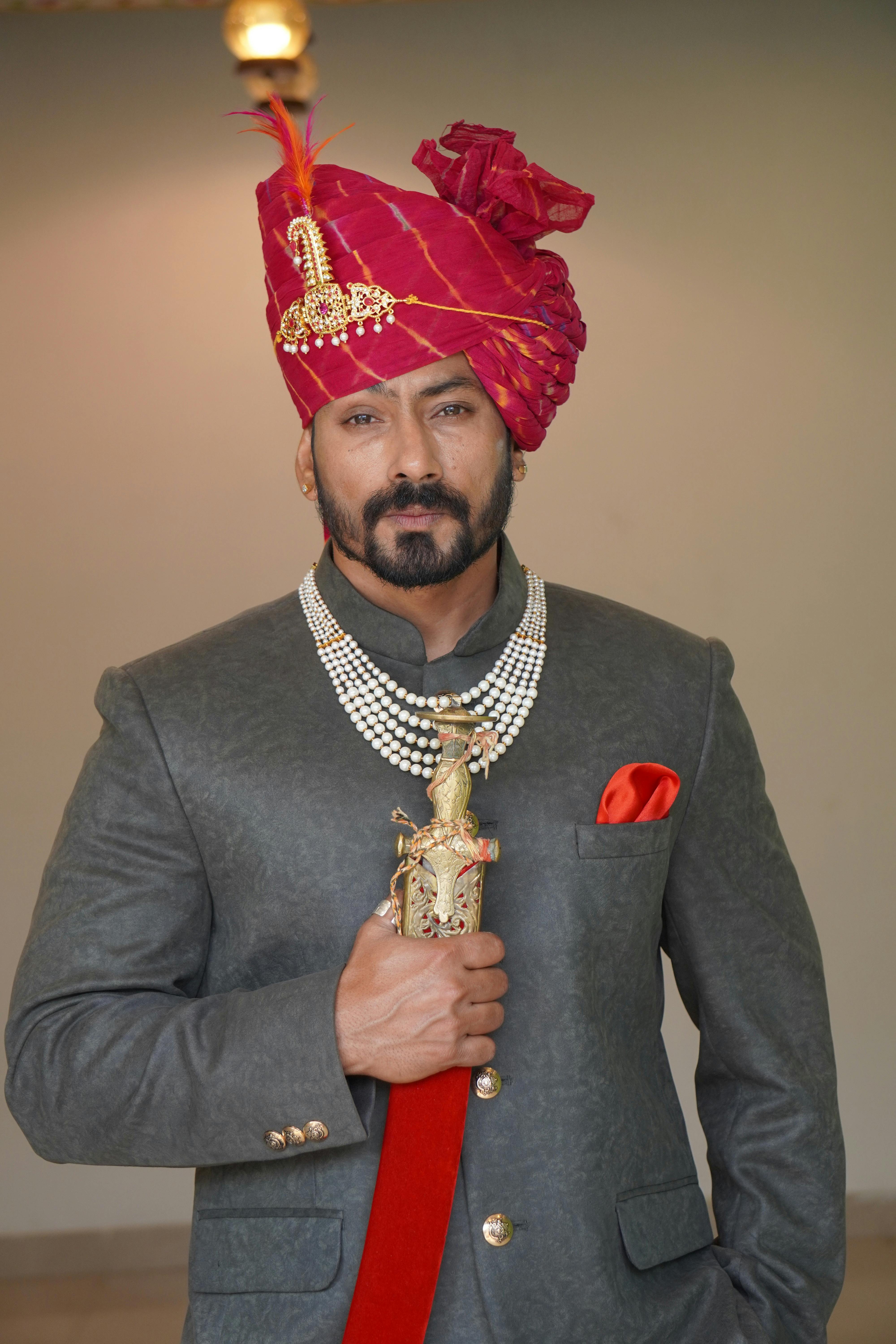 Portrait of an Indian groom wearing a turban and traditional attire, exuding elegance.