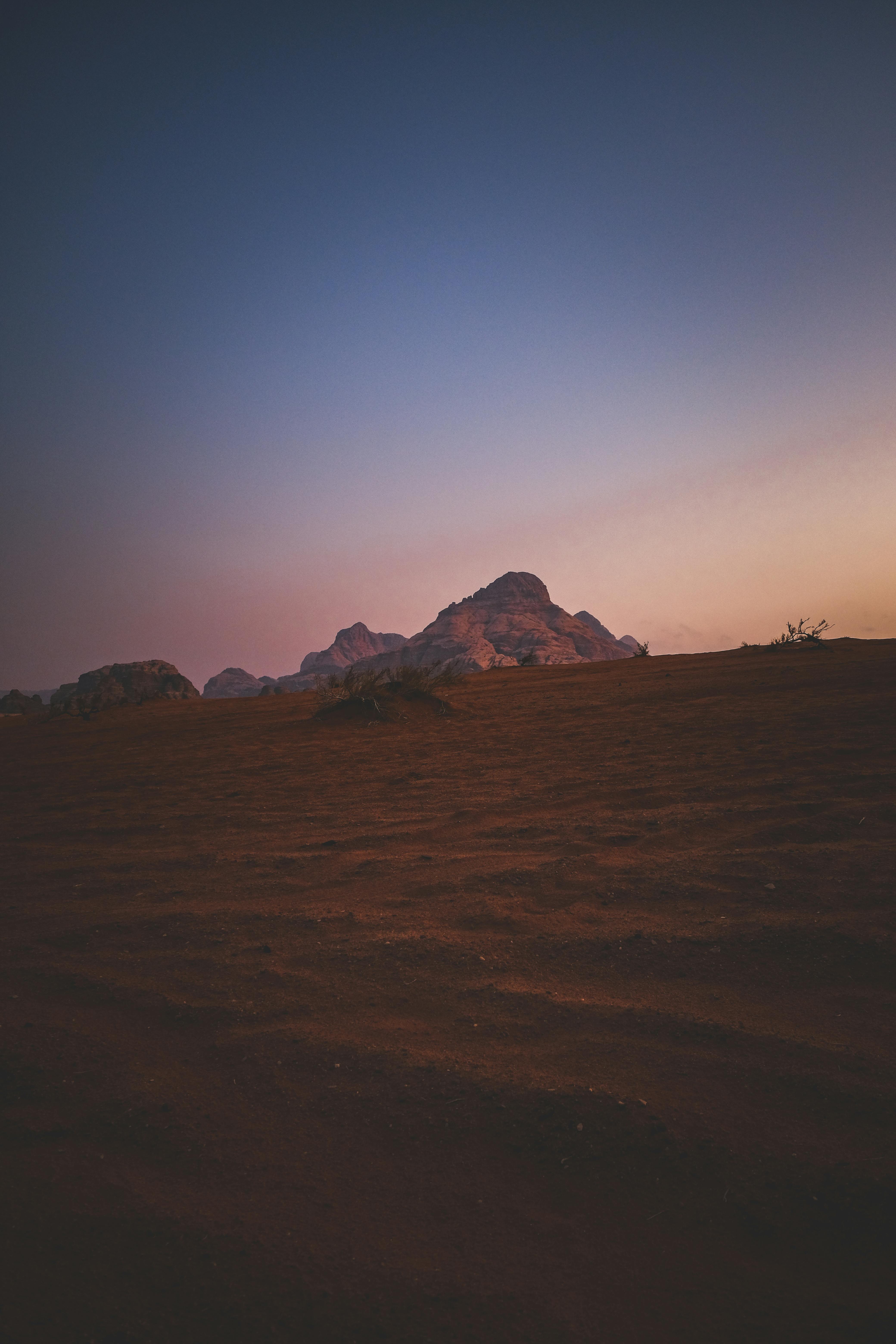 Captivating view of desert mountains with warm sunset hues painting the evening sky.