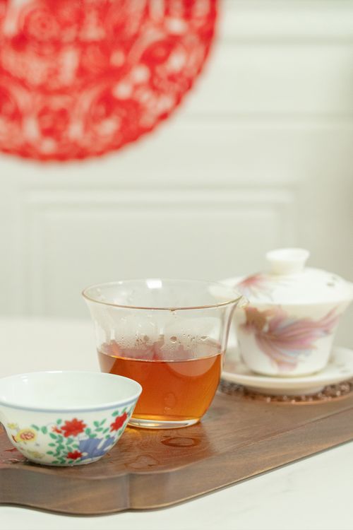 Free A beautifully arranged tea set with floral teacups on a wooden tray. Perfect for a serene tea time. Stock Photo