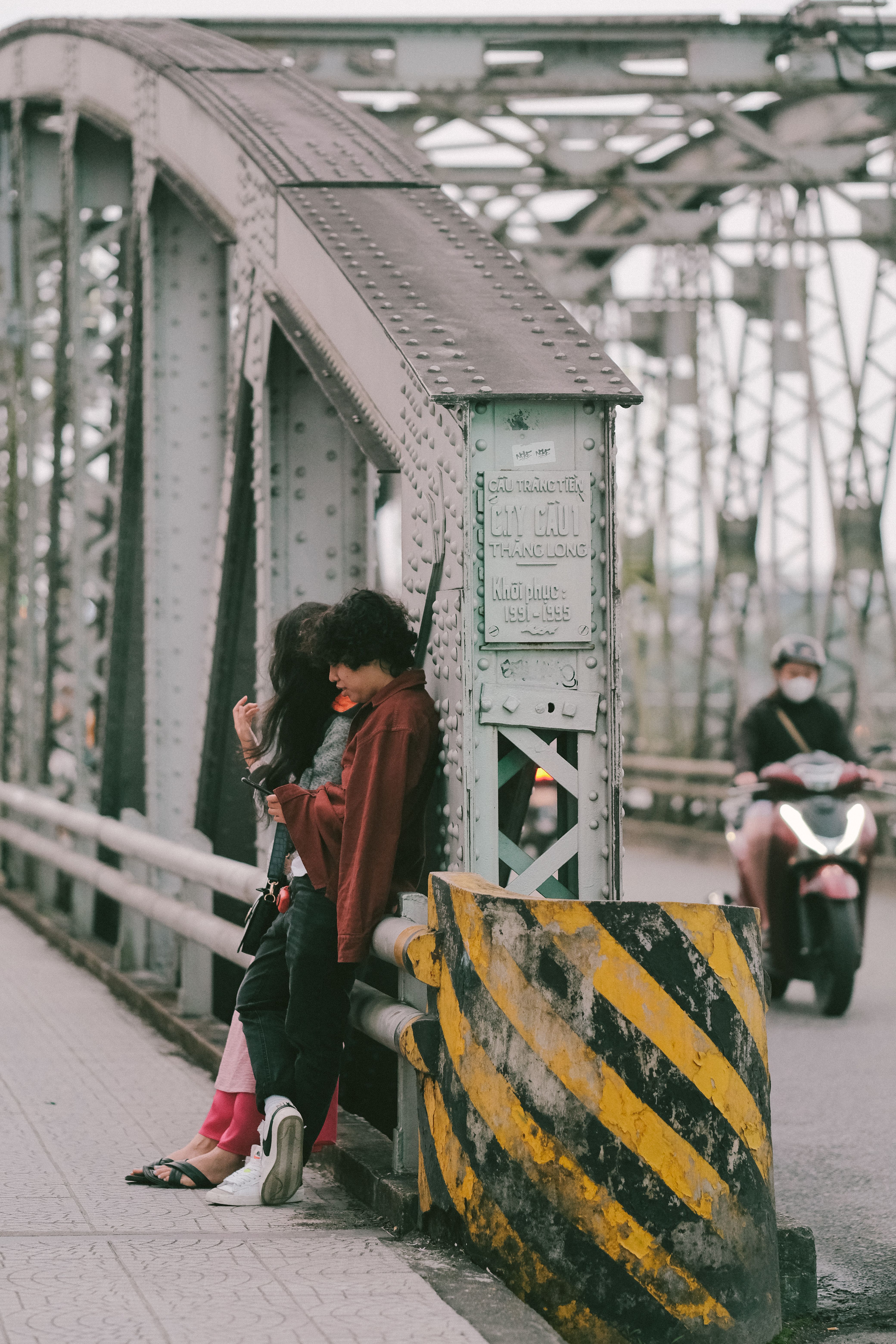 Couple Sitting on the Railing of the Bridge · Free Stock Photo