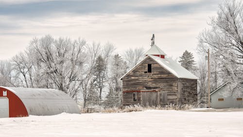 Wooden Barn on a Snowy Farm 
