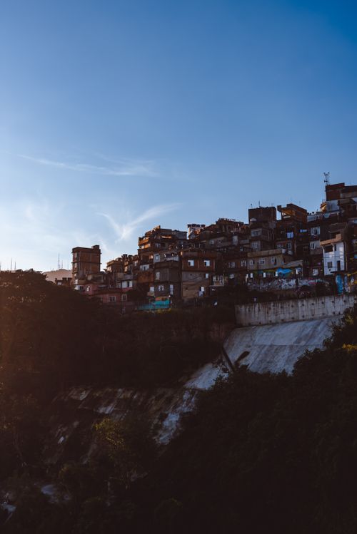 Free Scenic view of favela houses on a hillside in Rio de Janeiro during sunset, showcasing urban density and vibrant colors. Stock Photo