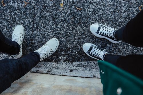 Free Casual sneakers from a top view on urban pavement, perfect for lifestyle scenes. Stock Photo