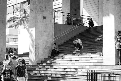 People Sitting on the Steps of a Building 