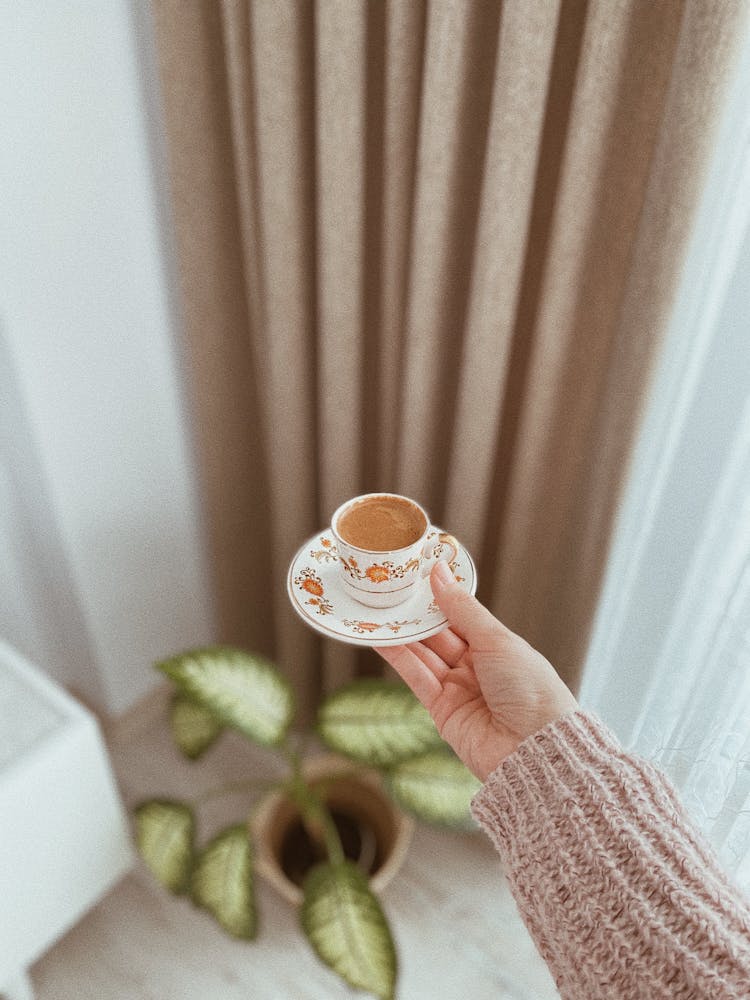 Hand Holding A Cup With Coffee