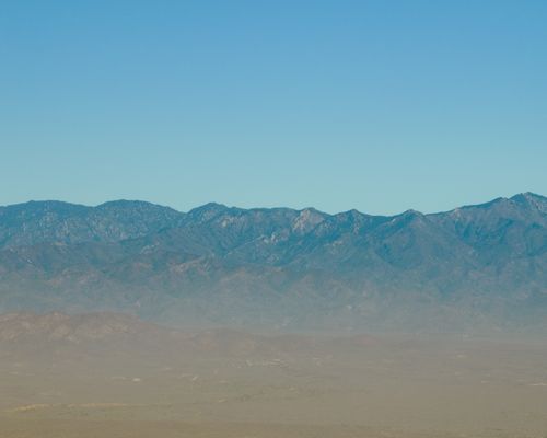 Free Blue skies and mountain range create a serene landscape in Todos Santos, Mexico. Perfect for nature enthusiasts. Stock Photo