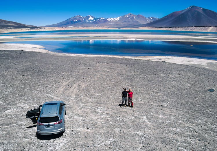 Couple By Lake Among Mountains