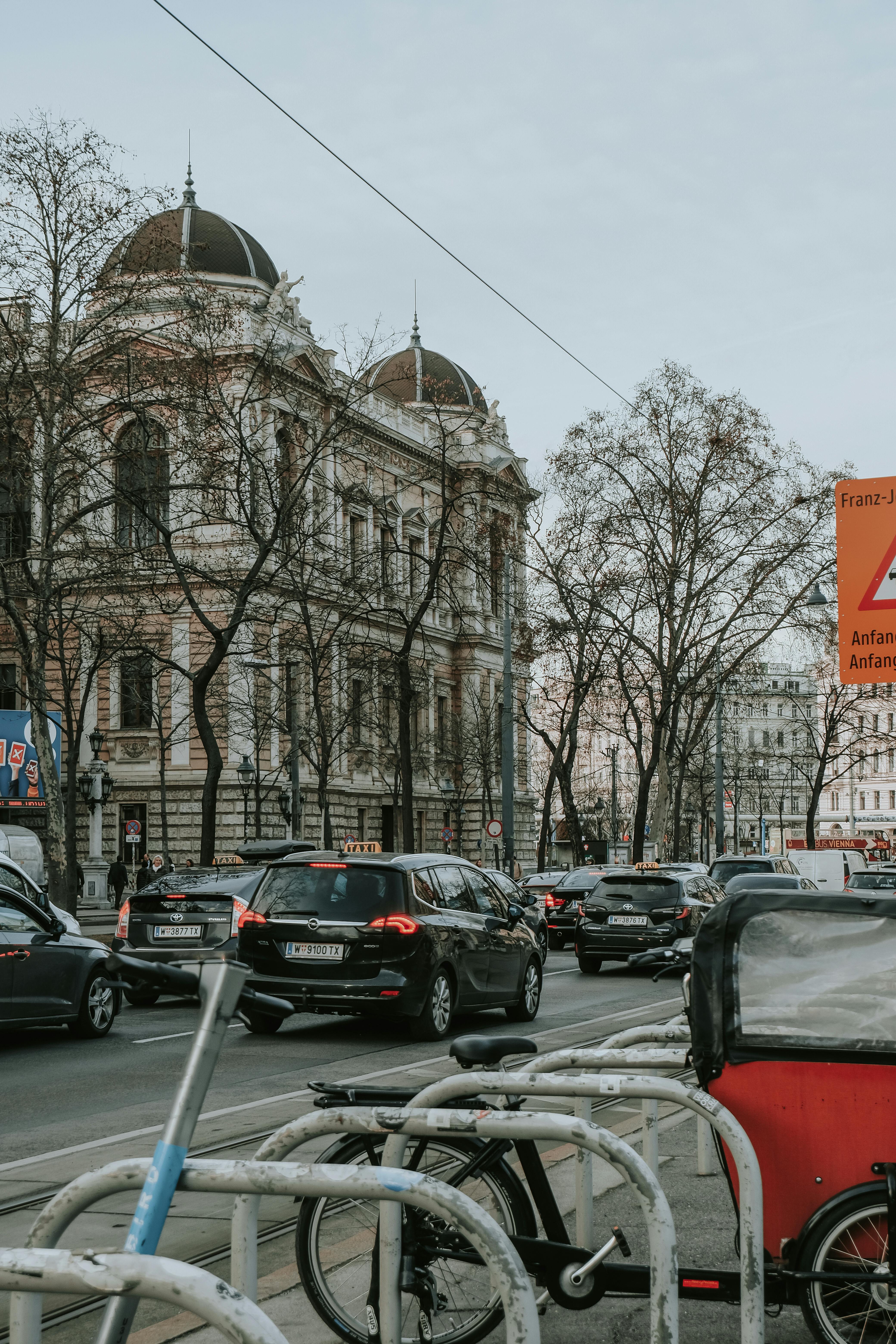 a city street with cars and bicycles