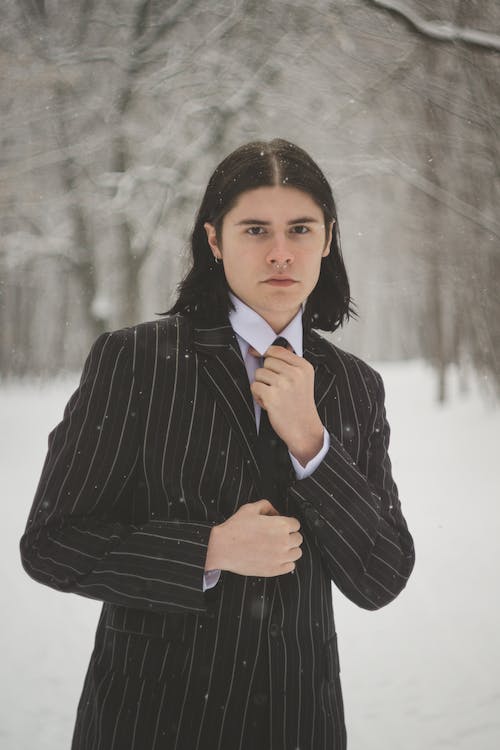 Young Man in a Suit Posing Outdoors in Winter 