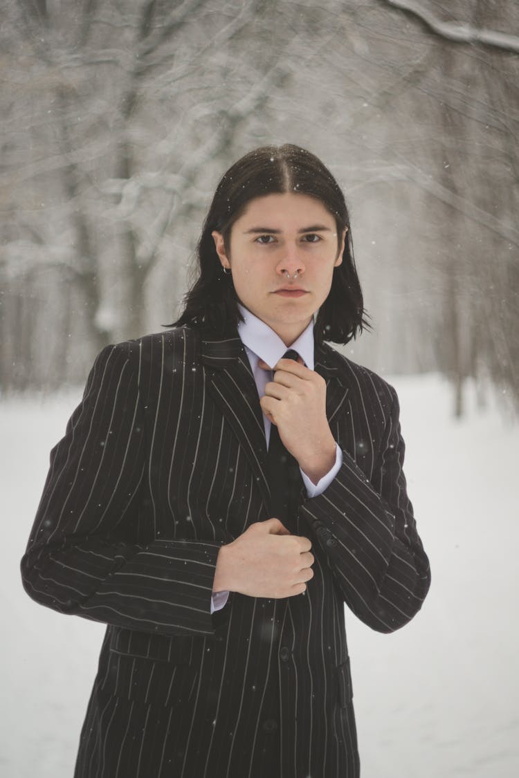 Young Man In A Suit Posing Outdoors In Winter 