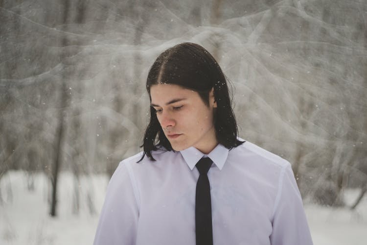 Young Man In A Suit Posing Outdoors In Winter 