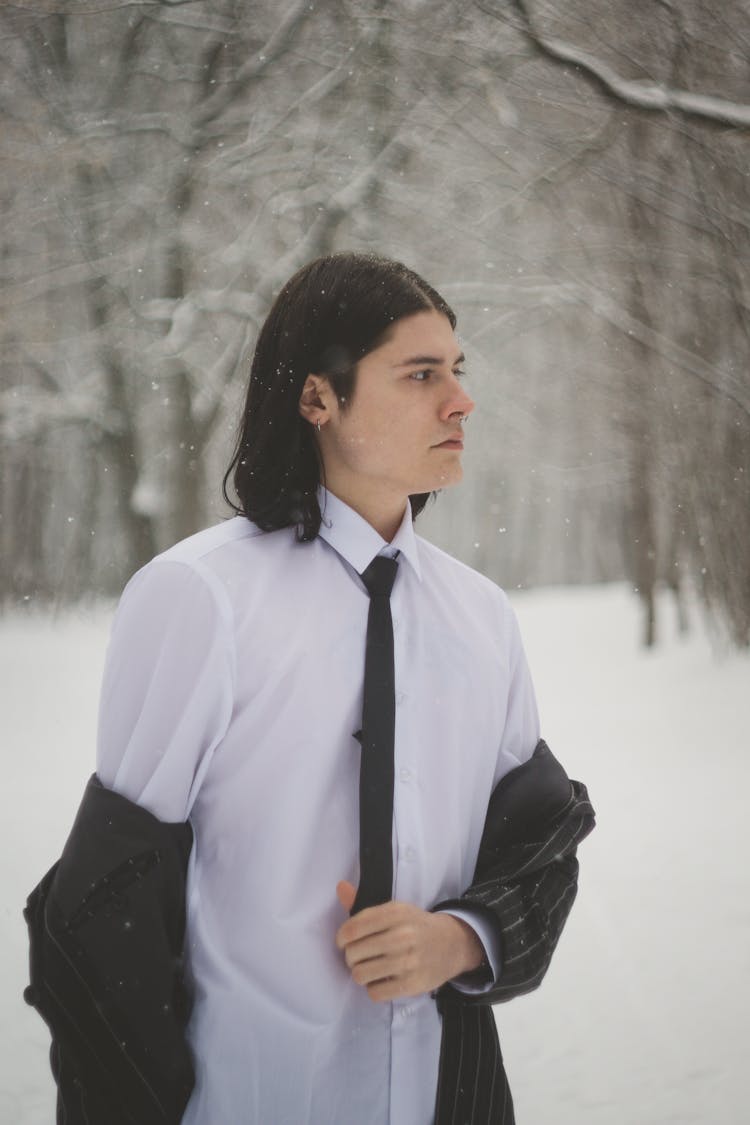 Young Man In A Suit Posing Outdoors In Winter 