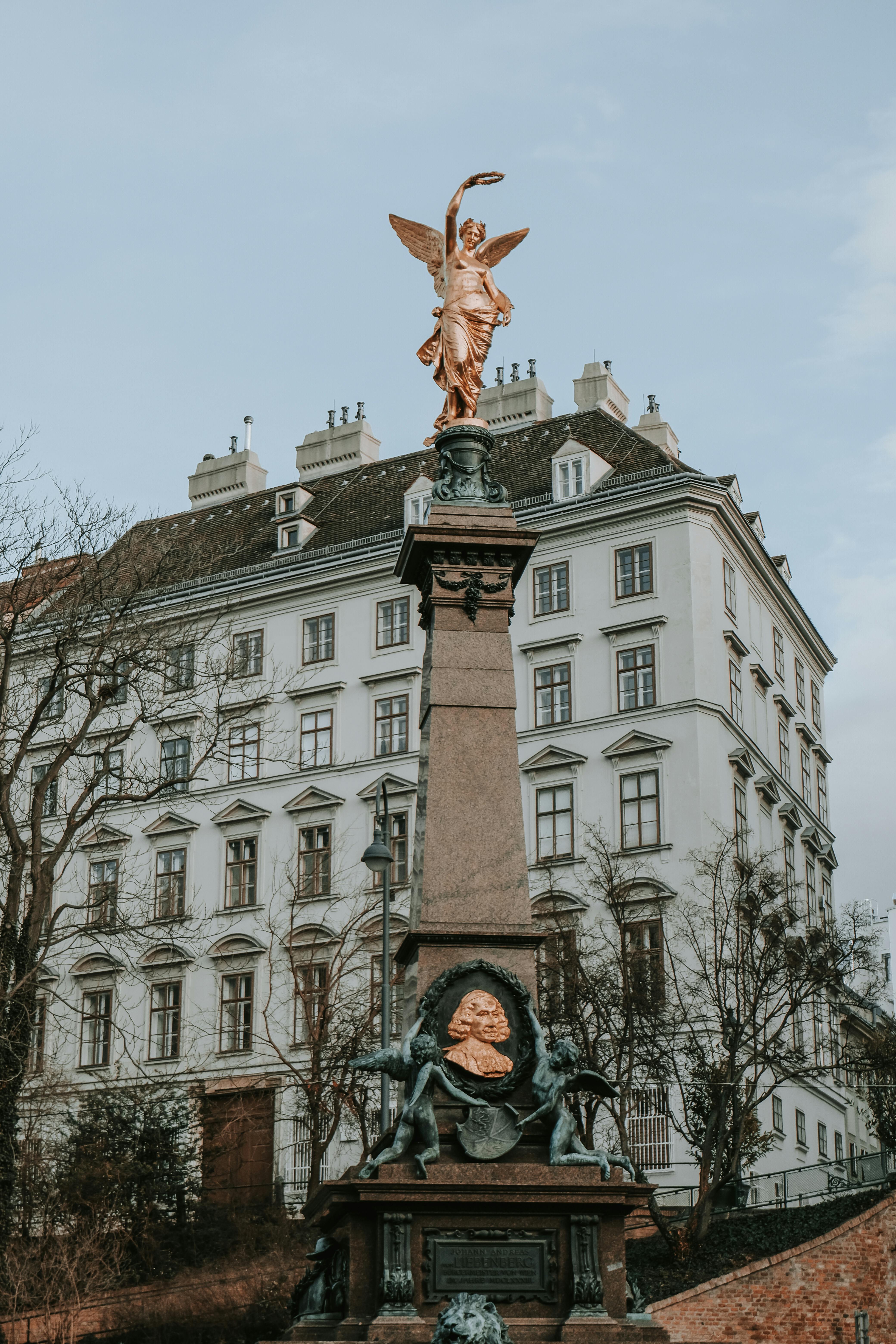 a statue of an angel in front of a building