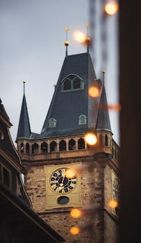 A captivating image of Prague's iconic clock tower with warm evening lights.