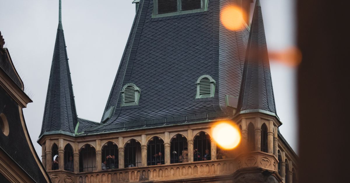 Clock Tower Color Designs A clock tower with lights on it · Free Stock Photo