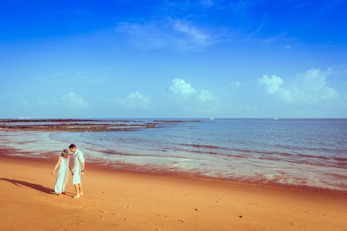 Bride and Groom Walking on Sand Beach